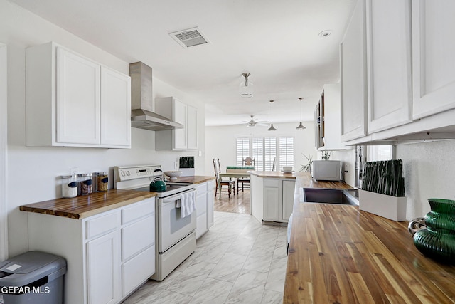 4731 Leeds Ave, El Paso, TX 79903 - kitchen with wall chimney range hood, white range with electric cooktop, wooden counters, and visible vents