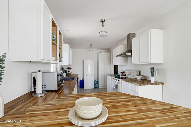 4731 Leeds Ave, El Paso, TX 79903 - kitchen featuring wall chimney range hood, white appliances, wood finished floors, white cabinetry, and wooden counters