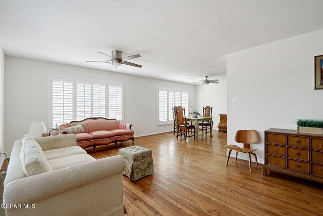 4731 Leeds Ave, El Paso, TX 79903 - living room featuring a ceiling fan, baseboards, and light wood-type flooring