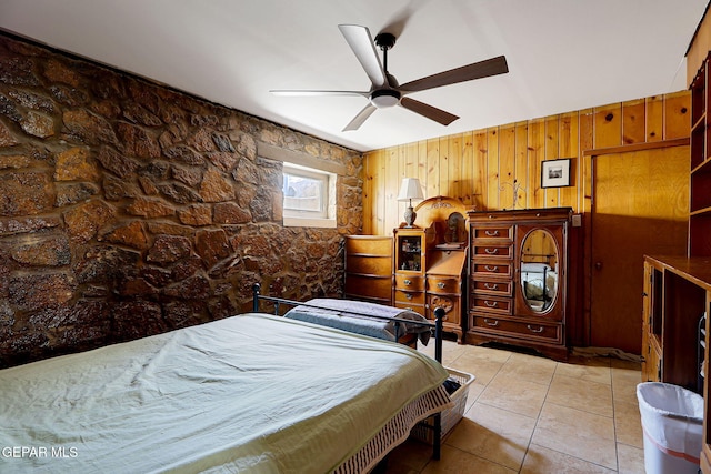 4731 Leeds Ave, El Paso, TX 79903 - bedroom with tile patterned flooring, wood walls, and a ceiling fan
