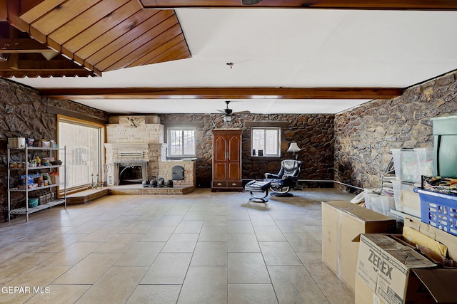 4731 Leeds Ave, El Paso, TX 79903 - unfurnished living room with ceiling fan, beamed ceiling, a large fireplace, and tile patterned flooring