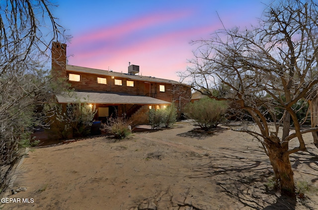 4731 Leeds Ave, El Paso, TX 79903 - back of property with central air condition unit and a chimney