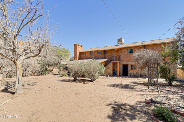 4731 Leeds Ave, El Paso, TX 79903 - back of property featuring a chimney and stone siding