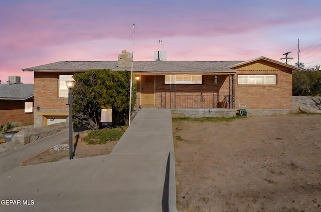 4731 Leeds Ave, El Paso, TX 79903 - view of front of home with a chimney, a porch, and brick siding