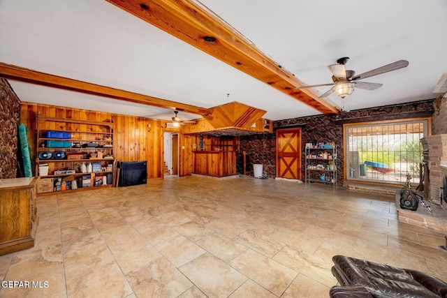4731 Leeds Ave, El Paso, TX 79903 - unfurnished living room with wood walls, a ceiling fan, and beamed ceiling