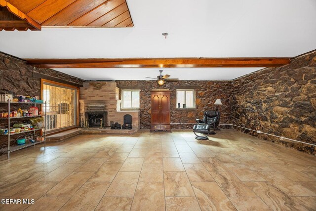 4731 Leeds Ave, El Paso, TX 79903 - unfurnished room with a large fireplace, a ceiling fan, and beam ceiling