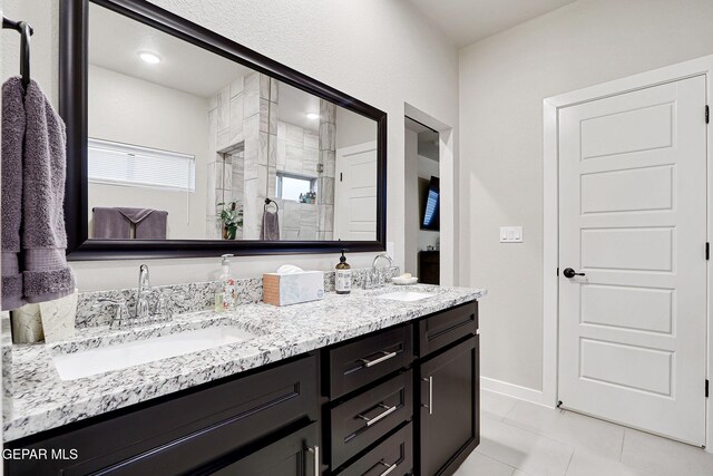7809 Enchanted Circle Dr, El Paso, TX 79911 - full bath with a shower stall, double vanity, baseboards, and tile patterned flooring