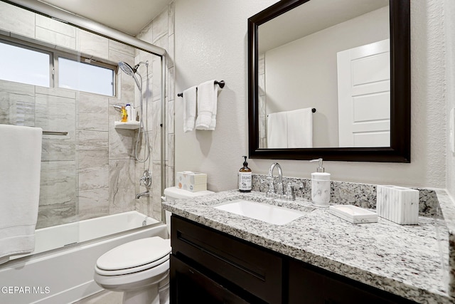 7809 Enchanted Circle Dr, El Paso, TX 79911 - full bath with bath / shower combo with glass door, vanity, toilet, and a textured wall