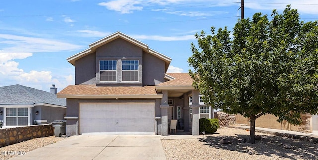 traditional-style home with stucco siding, an attached garage, concrete driveway, and a shingled roof