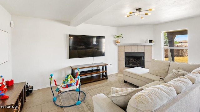 living room with tile patterned flooring, a chandelier, a fireplace, beamed ceiling, and baseboards