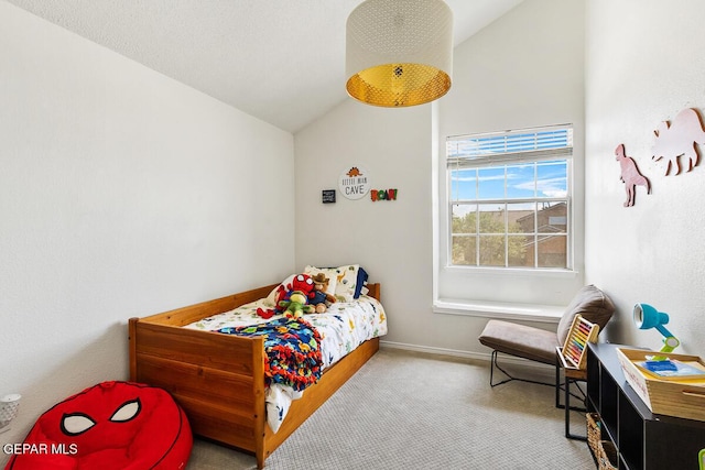 bedroom with lofted ceiling, carpet flooring, and baseboards