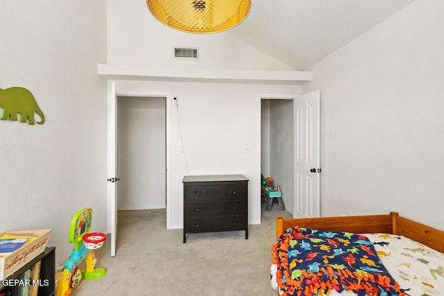 carpeted bedroom featuring lofted ceiling