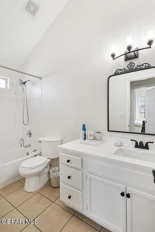 full bath with toilet, vanity, tile patterned floors, lofted ceiling, and shower / bath combination