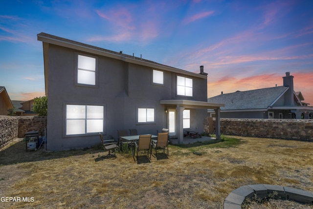 841 Dakota River Ave, El Paso, TX 79932 - back of property with stucco siding, a patio area, and an outdoor fire pit