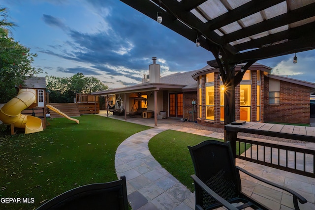 2250 Nancy Mcdonald Dr, El Paso, TX 79936 - yard at dusk featuring a playground, a patio area, a yard, and a pergola