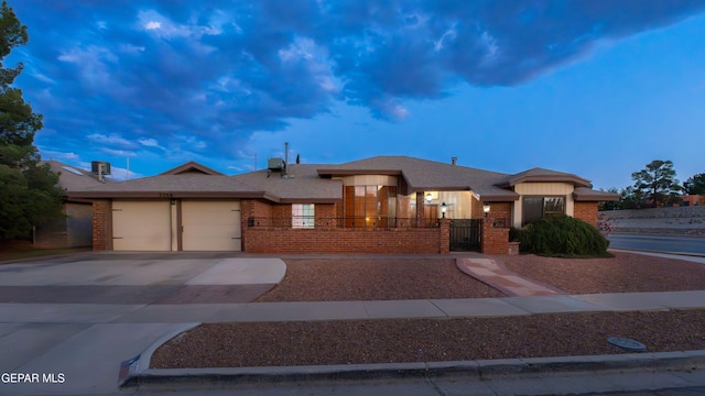2250 Nancy Mcdonald Dr, El Paso, TX 79936 - view of front facade featuring brick siding, driveway, an attached garage, a fenced front yard, and a gate