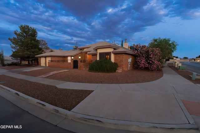 2250 Nancy Mcdonald Dr, El Paso, TX 79936 - single story home with driveway, an attached garage, brick siding, and a chimney