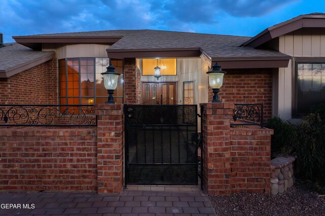 2250 Nancy Mcdonald Dr, El Paso, TX 79936 - property entrance with brick siding, roof with shingles, fence, and a gate