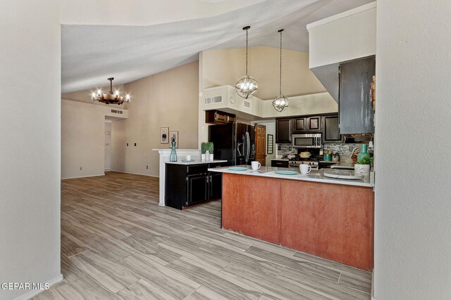 2250 Nancy Mcdonald Dr, El Paso, TX 79936 - kitchen featuring stainless steel appliances, a chandelier, a peninsula, light countertops, and pendant lighting