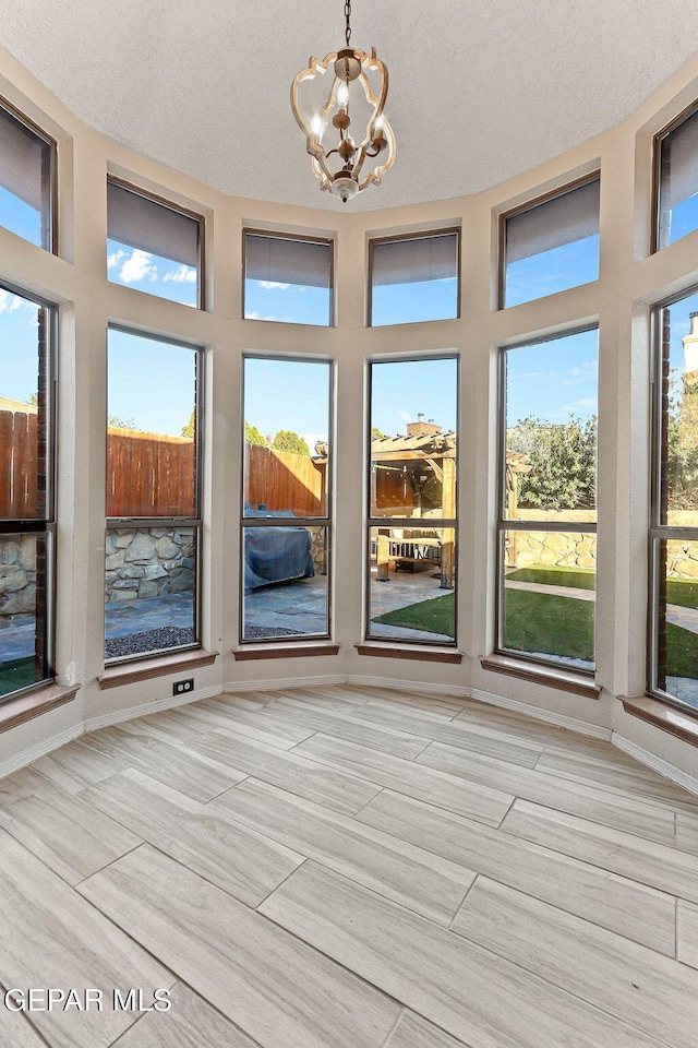 2250 Nancy Mcdonald Dr, El Paso, TX 79936 - unfurnished sunroom with a chandelier and a textured ceiling