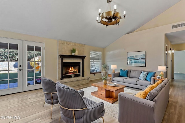 2250 Nancy Mcdonald Dr, El Paso, TX 79936 - living area featuring a chandelier, french doors, high vaulted ceiling, light wood-style flooring, and a fireplace