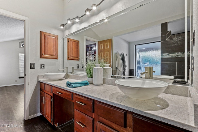 2250 Nancy Mcdonald Dr, El Paso, TX 79936 - full bath featuring double vanity, wood finished floors, plenty of natural light, a textured ceiling, and baseboards