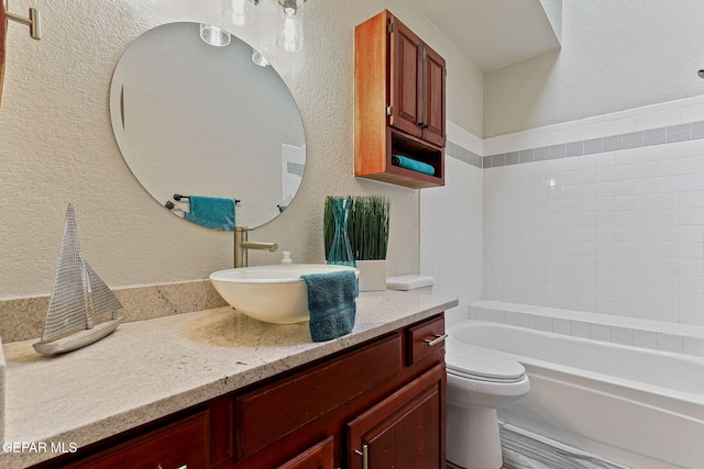 2250 Nancy Mcdonald Dr, El Paso, TX 79936 - bathroom featuring a textured wall, toilet, and vanity