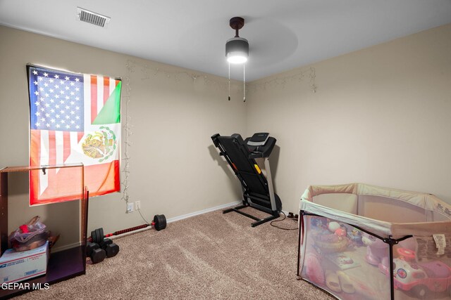 workout room with ceiling fan, carpet floors, baseboards, and visible vents