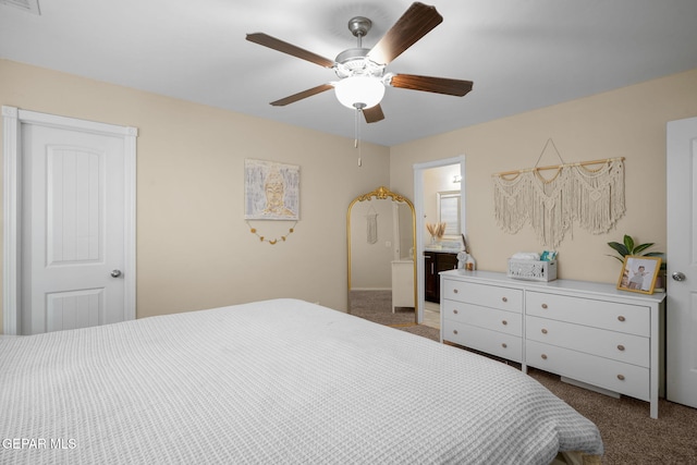 bedroom with ceiling fan, carpet, ensuite bath, and visible vents