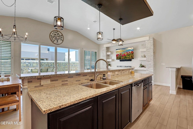 kitchen with dishwasher, a sink, lofted ceiling, a chandelier, and light wood finished floors