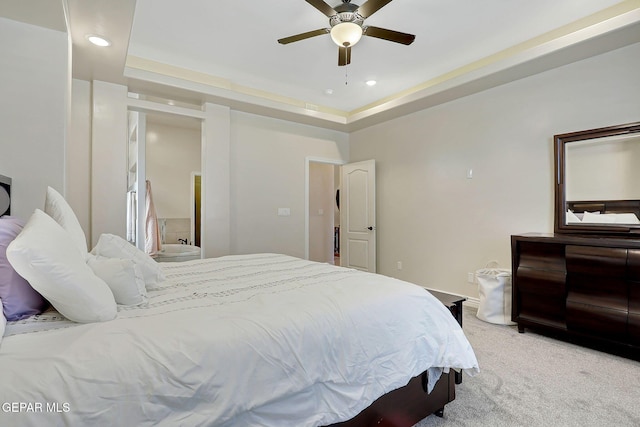 bedroom with light colored carpet, recessed lighting, a tray ceiling, and ceiling fan