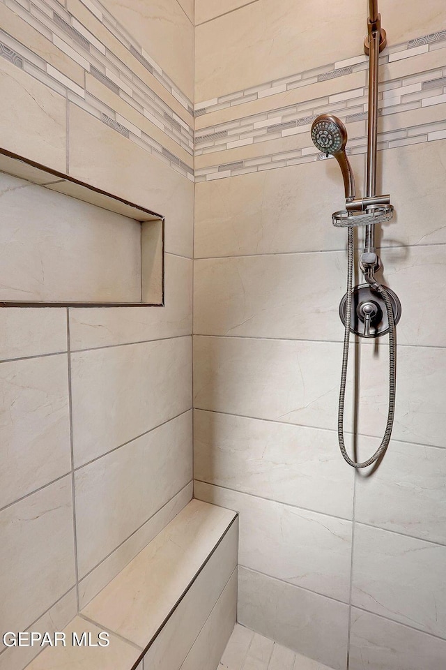 full bathroom with a tile shower