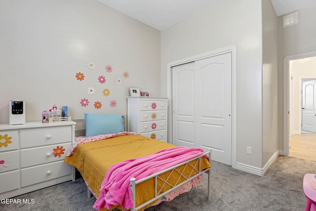 bedroom with carpet floors, a closet, and baseboards