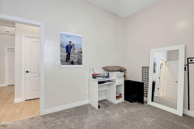 carpeted office space featuring baseboards