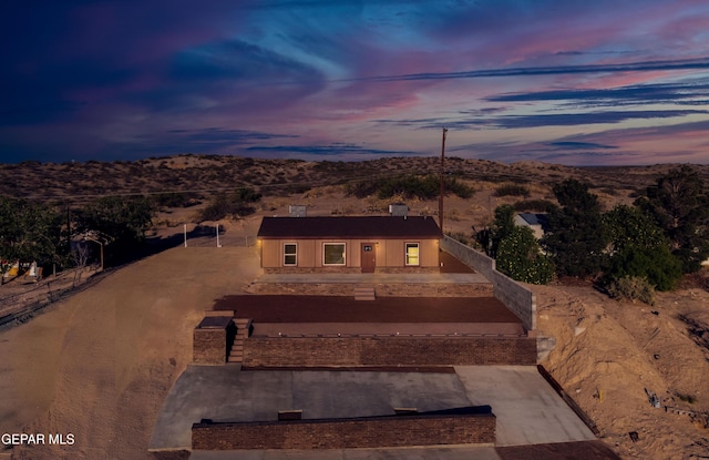 view of front of house with a mountain view and fence