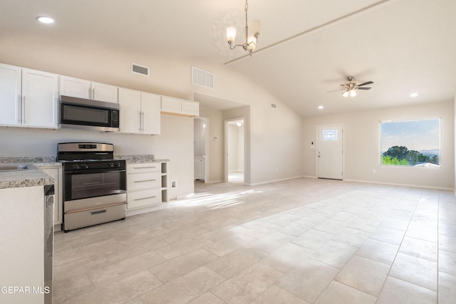 kitchen featuring range with gas cooktop, stainless steel microwave, lofted ceiling, white cabinetry, and a ceiling fan