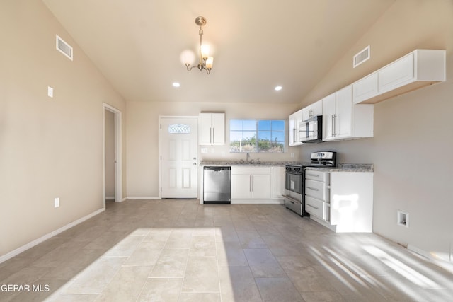 kitchen with stainless steel appliances, lofted ceiling, a chandelier, white cabinets, and light stone countertops