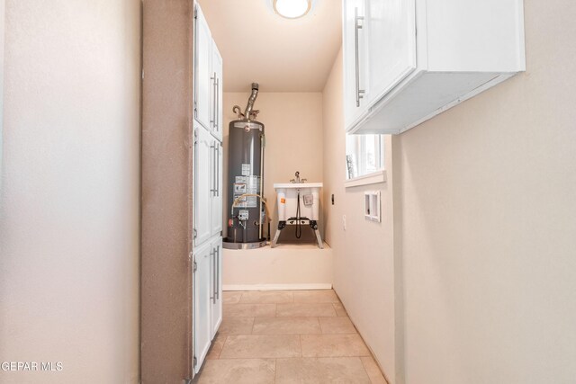 hallway with water heater and a sink