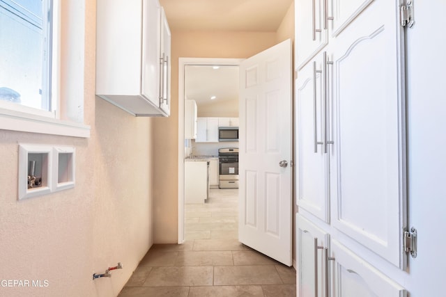 hallway featuring light tile patterned floors