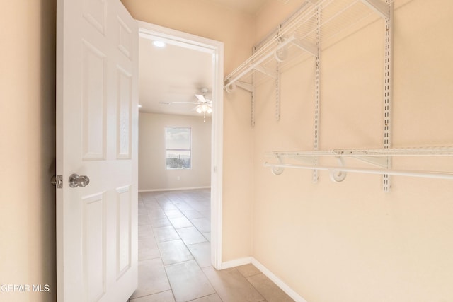 walk in closet with ceiling fan and light tile patterned floors