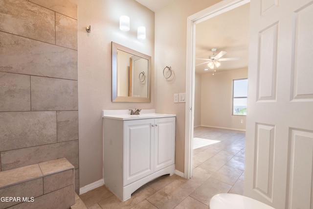 bathroom with ceiling fan, tile patterned flooring, vanity, and baseboards