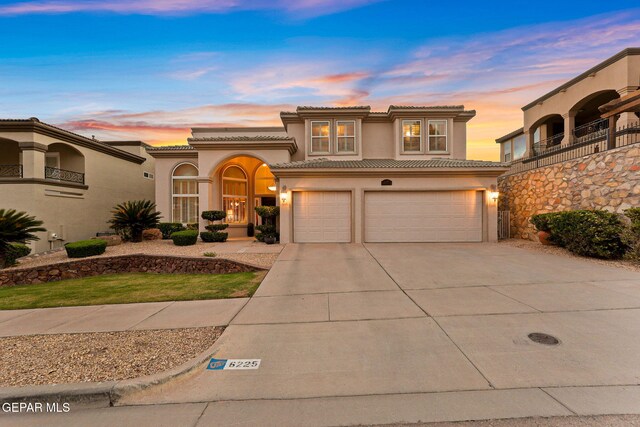 6225 Via Serena Dr, El Paso, TX 79912 - mediterranean / spanish home with stucco siding, driveway, a tile roof, and an attached garage