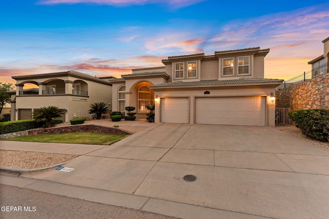 6225 Via Serena Dr, El Paso, TX 79912 - mediterranean / spanish-style home with stucco siding, a garage, concrete driveway, a tile roof, and fence