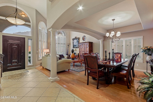 6225 Via Serena Dr, El Paso, TX 79912 - dining room featuring decorative columns, a chandelier, arched walkways, and healthy amount of natural light