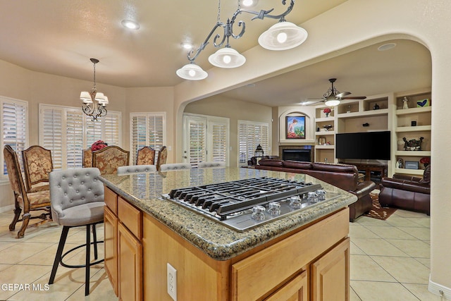 6225 Via Serena Dr, El Paso, TX 79912 - kitchen with stainless steel gas cooktop, light tile patterned floors, ceiling fan, and arched walkways