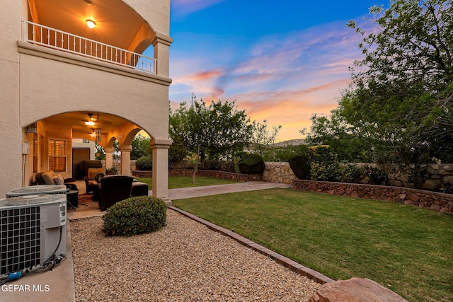 6225 Via Serena Dr, El Paso, TX 79912 - view of grassy yard with a patio, central AC unit, a balcony, and an outdoor living space