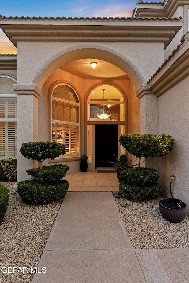 6225 Via Serena Dr, El Paso, TX 79912 - view of exterior entry featuring stucco siding and a tile roof