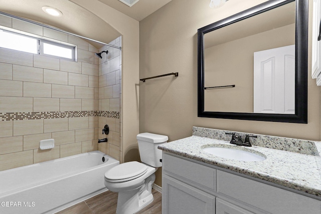 7541 Wolf Creek Dr, El Paso, TX 79911 - full bathroom with toilet, wood finished floors, vanity, shower / washtub combination, and baseboards