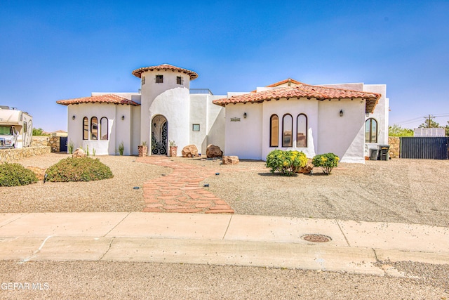 mediterranean / spanish-style home with stucco siding and a tiled roof