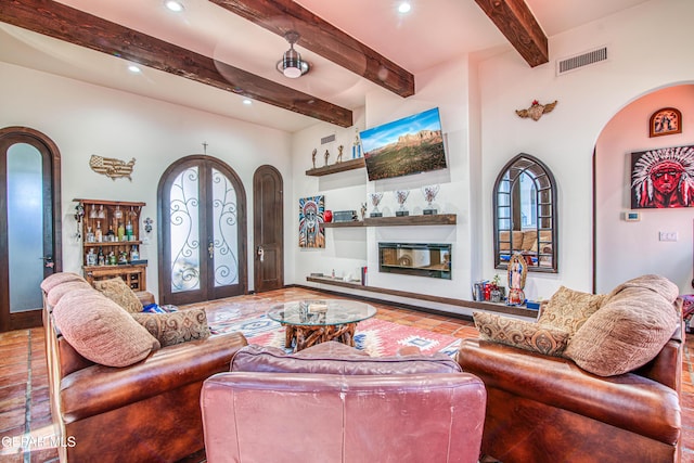 living room with arched walkways, french doors, beam ceiling, and recessed lighting